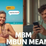 Two young adults reacting to a message, one relaxing happily at the beach while the other looks at their phone with a jealous expression, with a chat bubble showing “MBN,” representing must be nice slang.