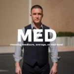“A man standing outdoors with large white text ‘MED’ over the image and smaller text below reading ‘meaning mediocre, average, or mid-level.’”